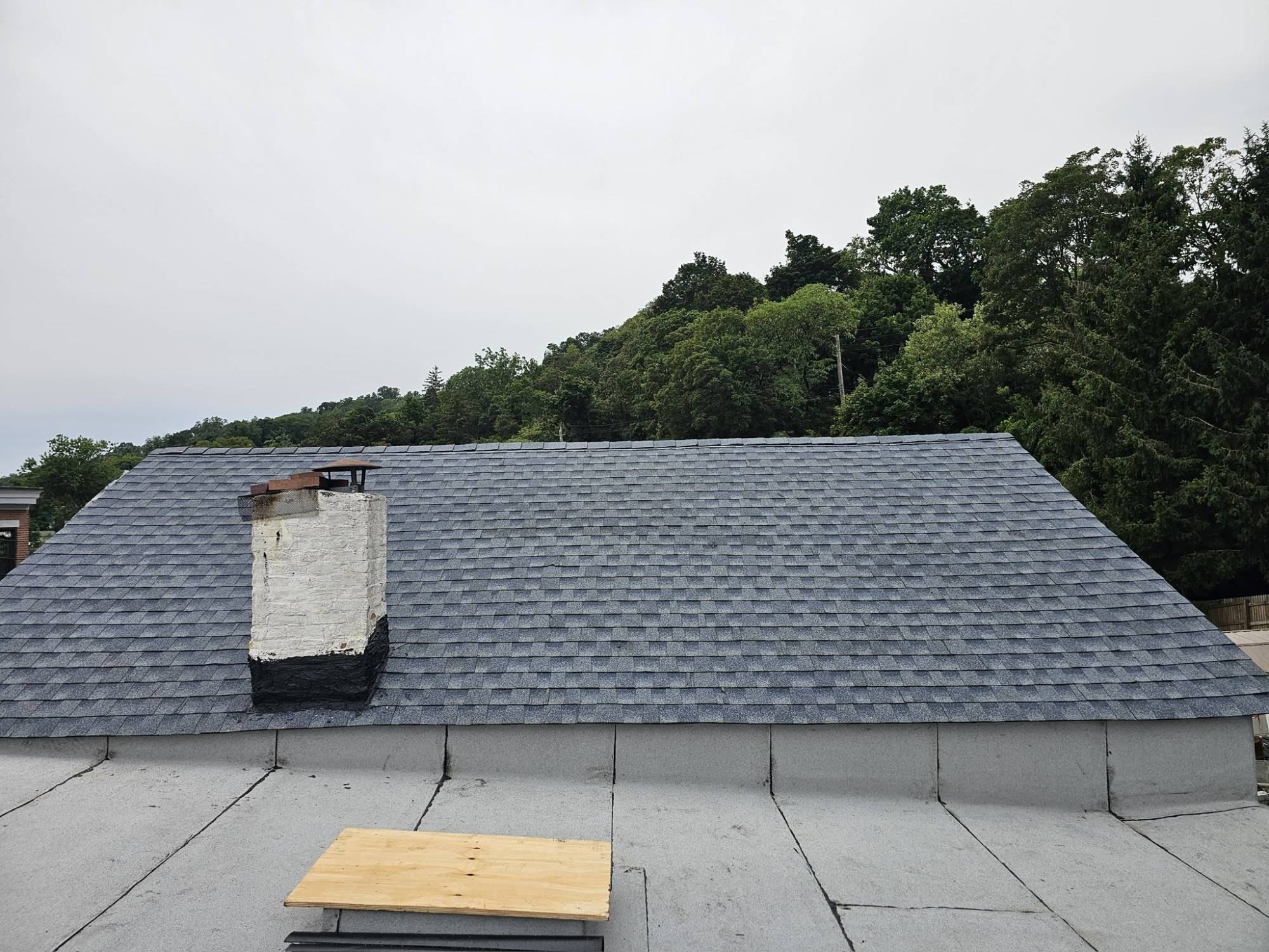 Brooklyn chimney with new step and counter flashing set into the mortar joints on a finished shingle roof