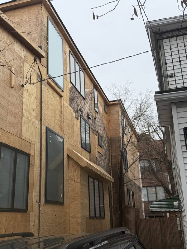 Full view home before siding roofing project Brooklyn