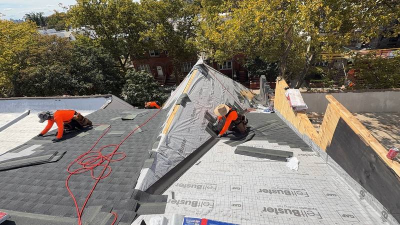 MLM roofer nailing shingles steep slope Brooklyn