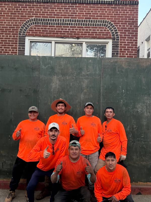 MLM Construction Group crew team photo Brooklyn NY orange shirts