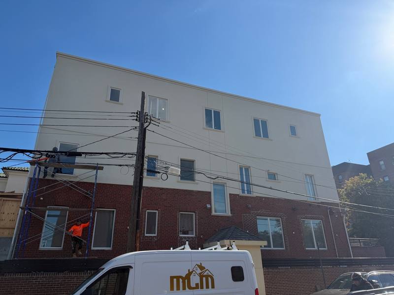 Stucco mid-progress entire building scaffold