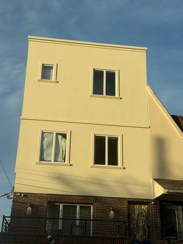 Completed stucco facade new addition floor Brooklyn NY