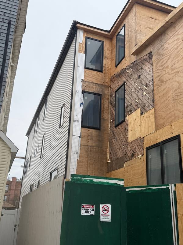 Old siding removed bare OSB before renovation Brooklyn