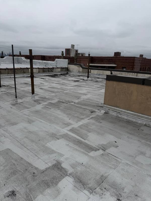 Old flat roof membrane deteriorated water damage